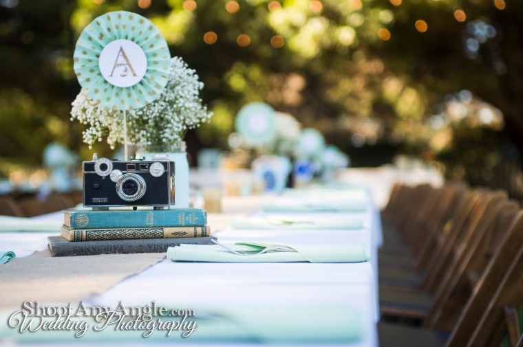 Old cameras and books as centerpieces.  Perfect for a photographer-author couple! http://ShootAnyAngle.com/weddings/